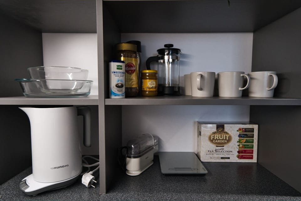 Kitchen accessories such as a kettle, cups, egg cooker and a scale for cooking