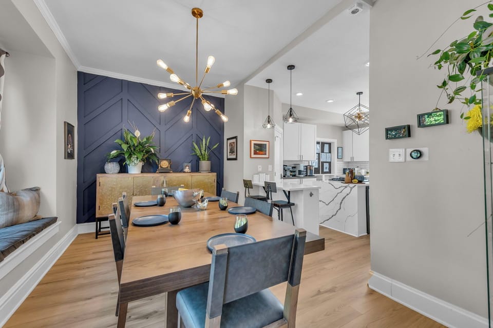 Stylish dining area & chef’s kitchen with bold accents and modern lighting