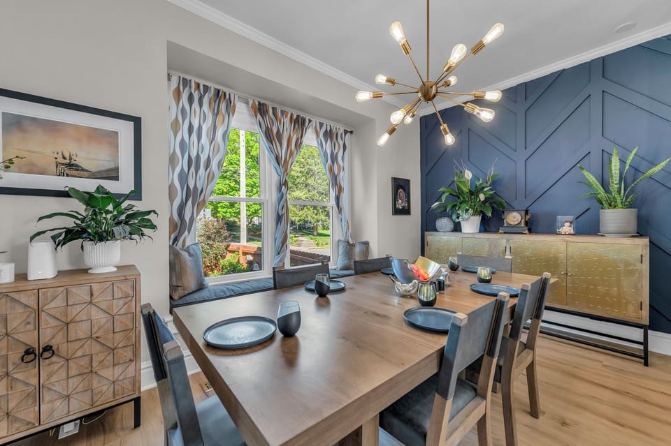 Bold designer dining room with luxe finishes and a cozy window seat