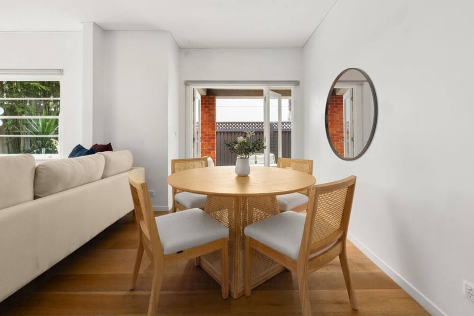 Enjoy relaxed meals at the timber dining table, positioned in the calming living area.