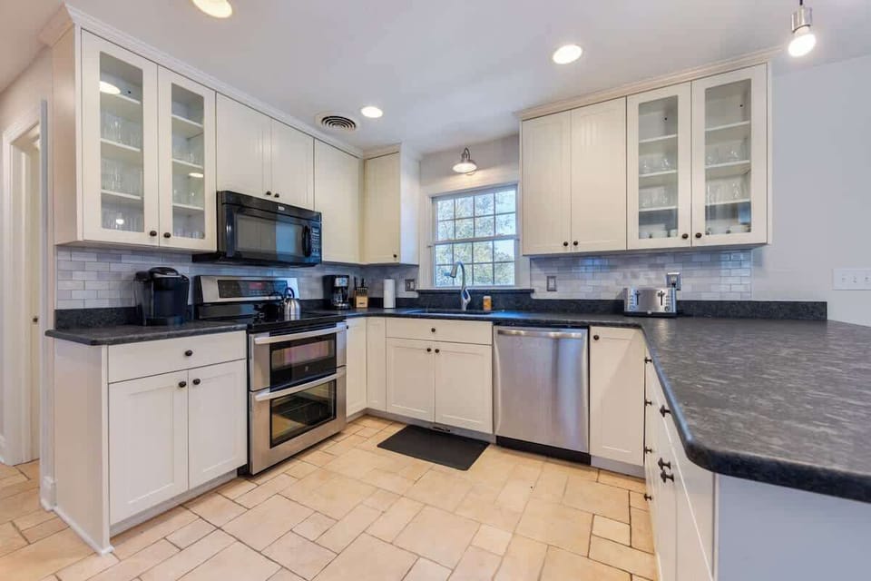 Entertain in style in this open and airy living room with dining space for 10! ✨ Enjoy gourmet meals prepared in the fully updated kitchen, equipped with all the amenities you need. Your perfect gathering space awaits! #HomeEntertaining #OpenConcept