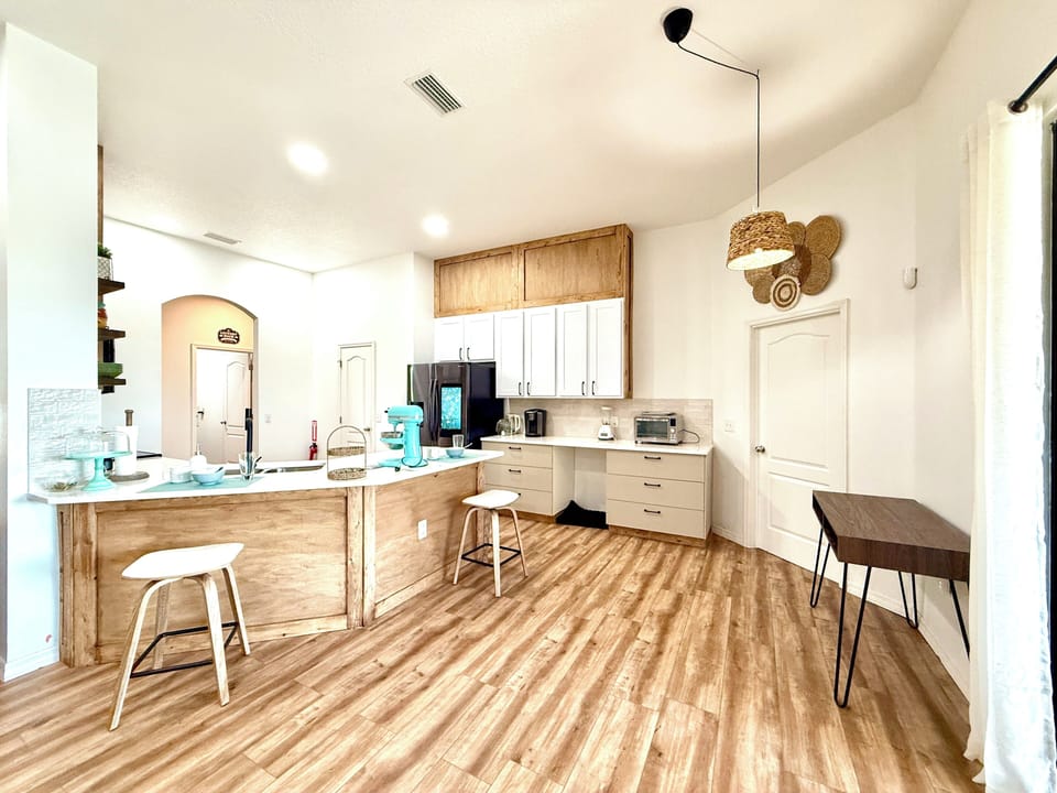 Kitchen features a breakfast bar, cabinetry, and all essential appliances.