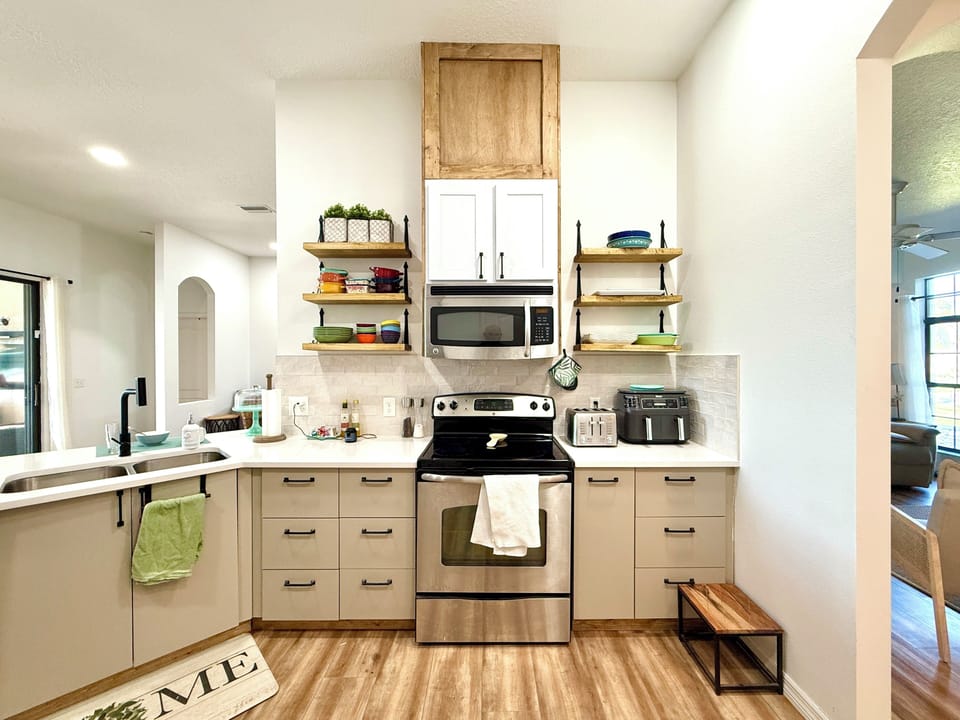 Kitchen features a breakfast bar, cabinetry, and all essential appliances.