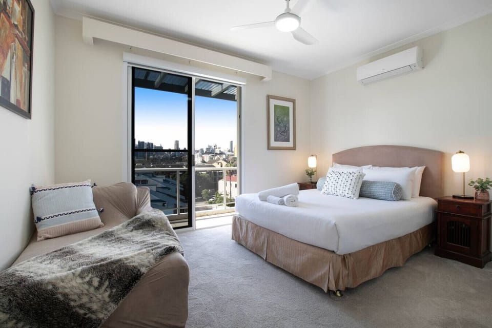 Primary Bedroom | Rest comfortably in the spacious room with air conditioning, a sitting area and balcony access.