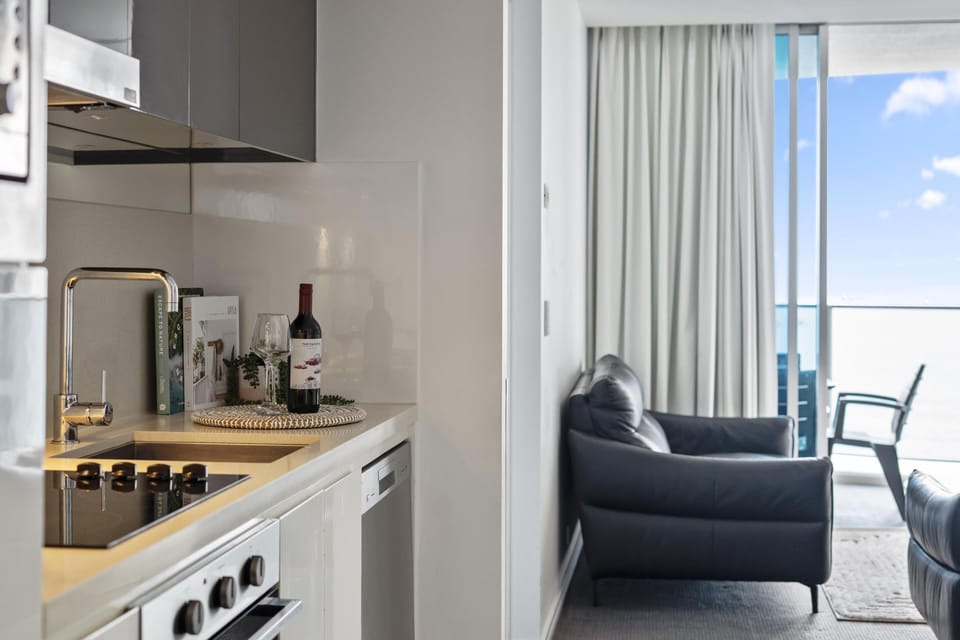 Fully equipped modern kitchen is right next to the living area