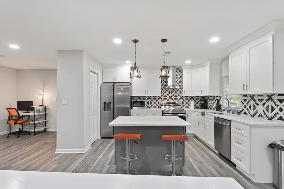 Open concept layout, where the kitchen island seamlessly connects to the welcoming living room.