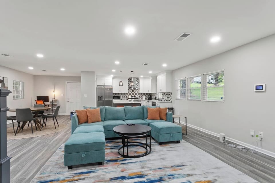 Seamless togetherness and personal space coexist in this inviting living room. From this vantage point, you can glimpse the kitchen and workstation, allowing family and friends to stay connected while attending to their individual activities.