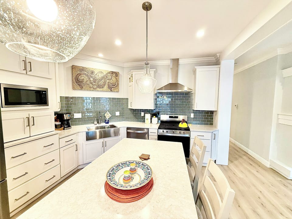 Serve breakfast or enjoy drinks around this bright kitchen island, the perfect spot to start or end your Marblehead days together.