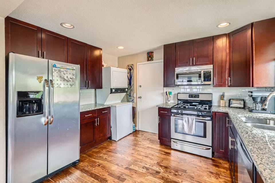The kitchen comes the stainless steel appliances, a gas range, and laundry machines