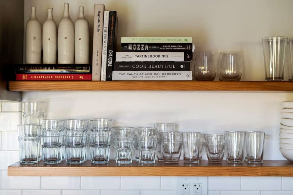 Kitchen cabinet fully stocked with elegant glassware, ready for any occasion.