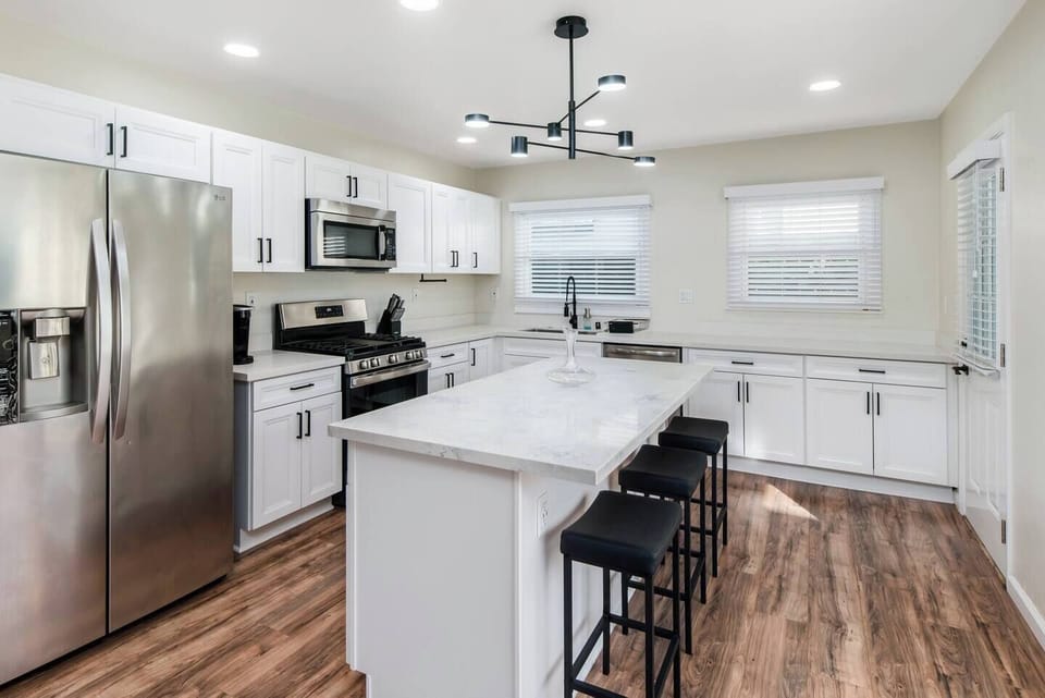Bright modern kitchen featuring sleek finishes & central island