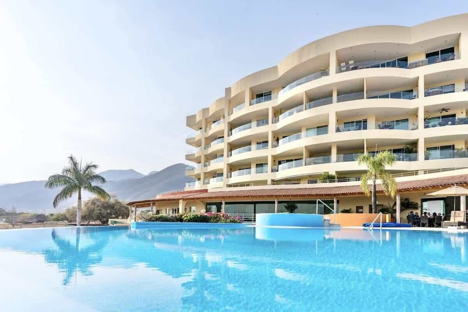 Solar-Heated Pool | 89-foot infinity pool (30 °C | 86 °F) surrounded by loungers and umbrellas