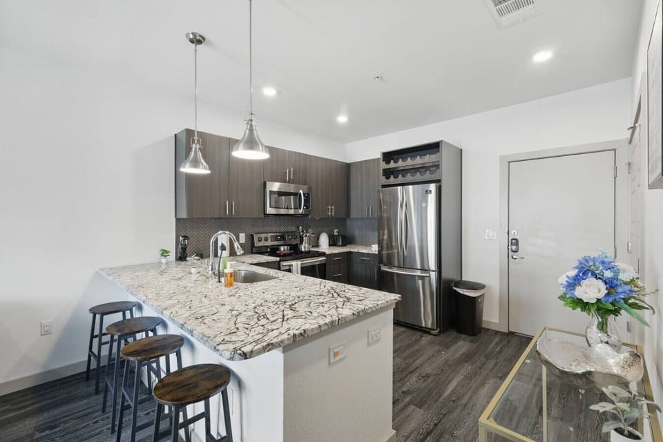 - Fully equipped kitchen with granite island and bar seating - Stainless steel appliances, coffee maker and modern cabinets - Open plan dining space perfect for extended stay travelers