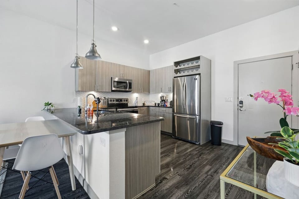 - Fully equipped kitchen with stainless steel appliances and island - Granite countertops, bar seating and pendant lighting - Open plan dining space perfect for entertaining guests