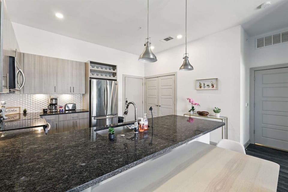 - Open concept apartment with kitchen island and lounge area - Smart TV, natural light and stylish decor accents - Prime location living with comfort and convenience