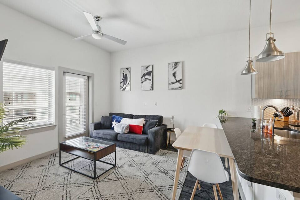 - Bright open living area with modern kitchen and dining - Smart TV, high ceilings and sleek contemporary design - Perfect space for extended stay comfort and convenience