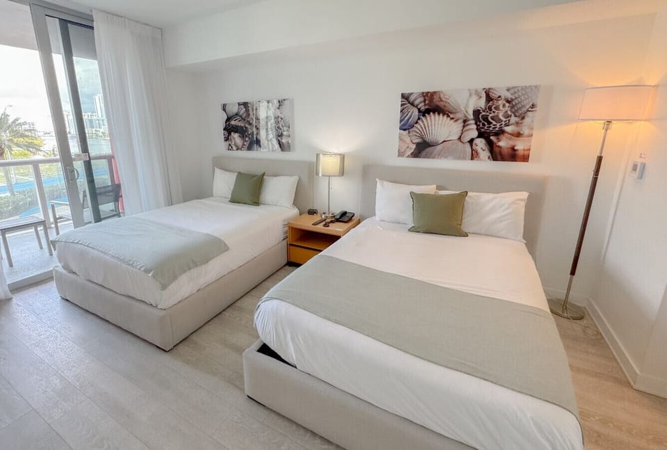 Spacious bedroom with balcony access and Smart TV.