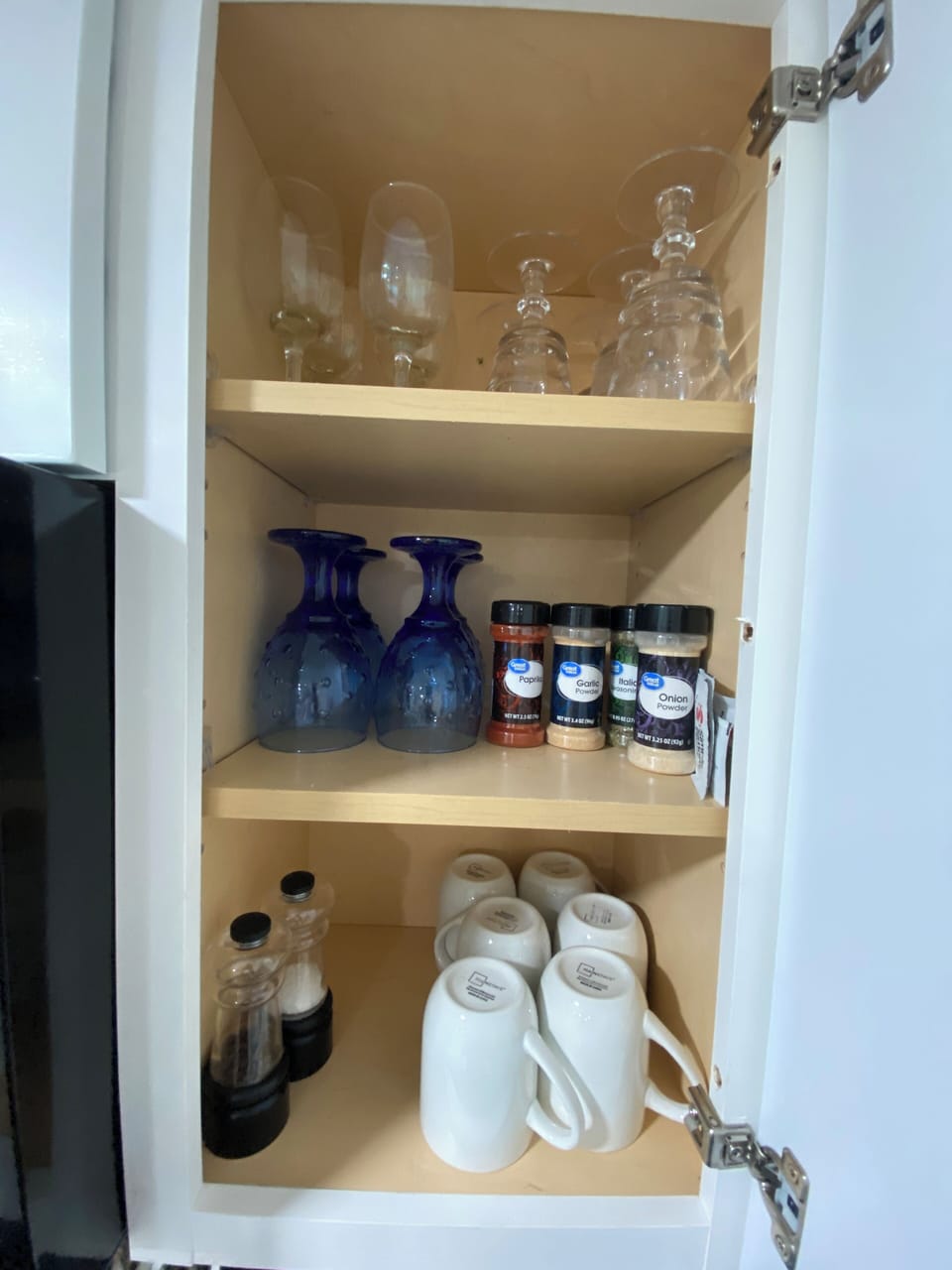Various shaped glasses, coffee cups and some spices. 