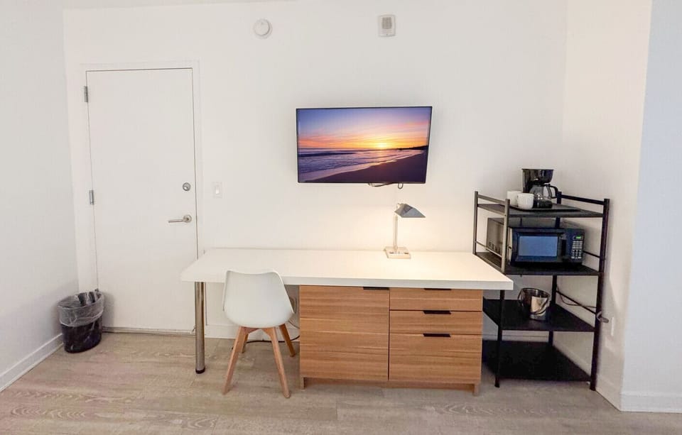 Well-equipped workspace and TV area inside the bedroom.