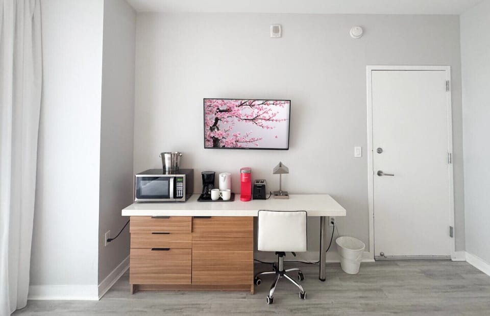 Well-equipped workspace and TV area inside the bedroom.