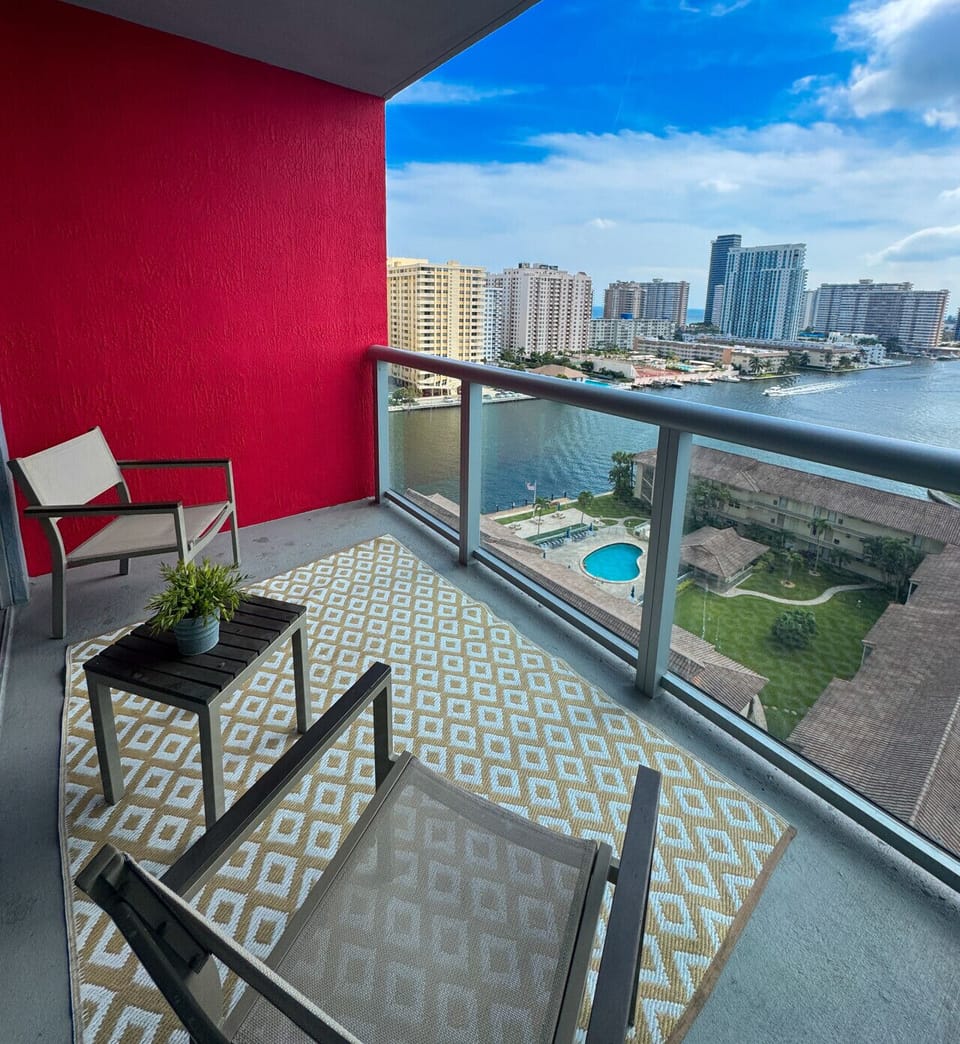 Private balcony with chairs and open city views.