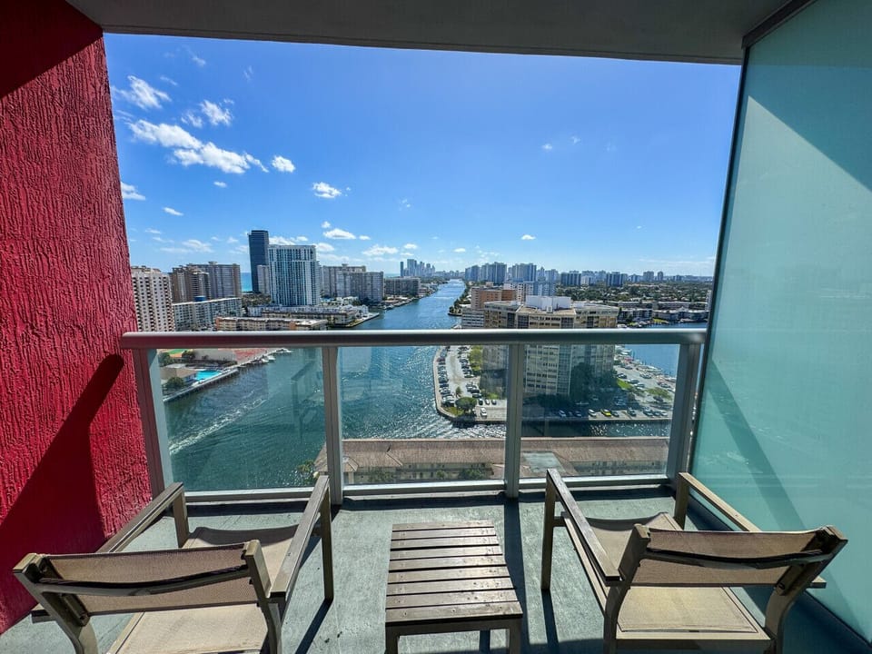 Private balcony with outdoor seating and skyline views.