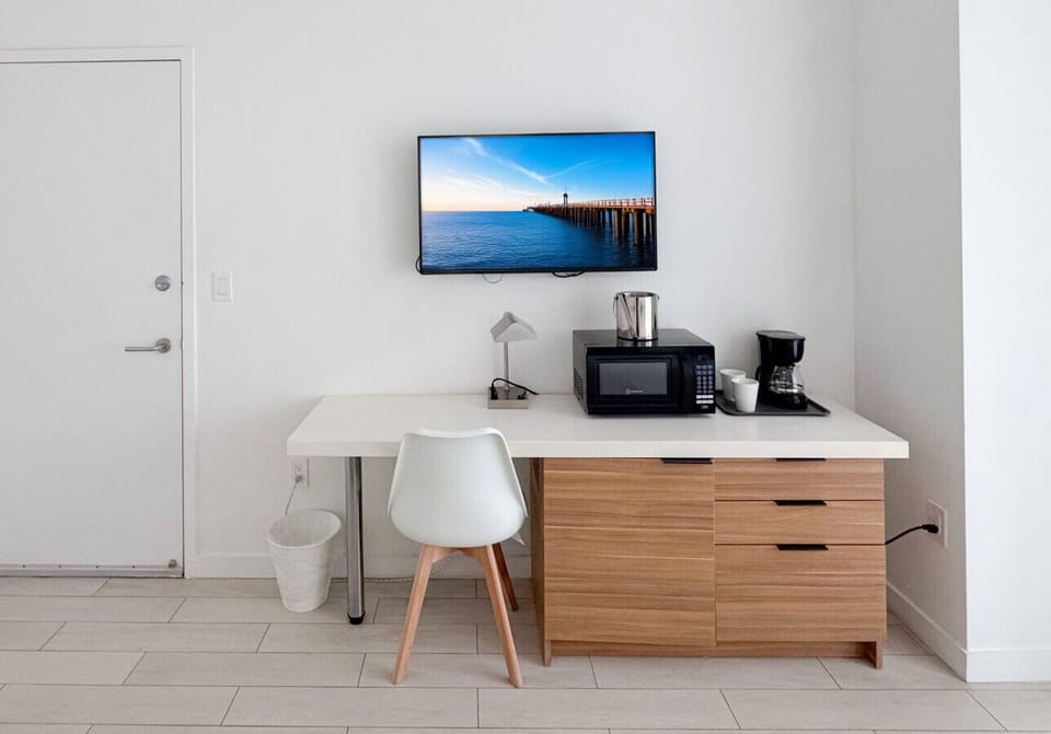 Well-equipped workspace and TV area inside the bedroom.