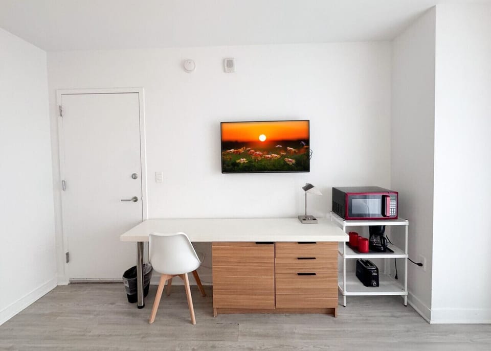 Well-equipped workspace and TV area inside the bedroom.