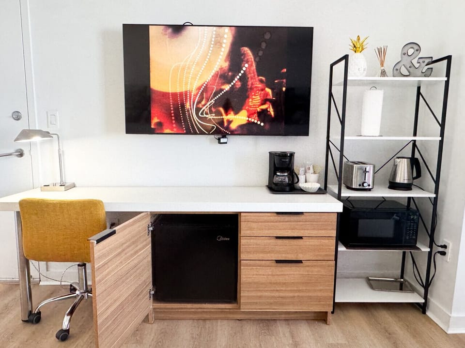 Well-equipped workspace and TV area inside the bedroom.