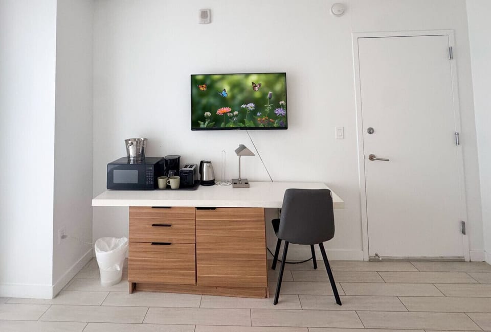 Well-equipped workspace and TV area inside the bedroom.