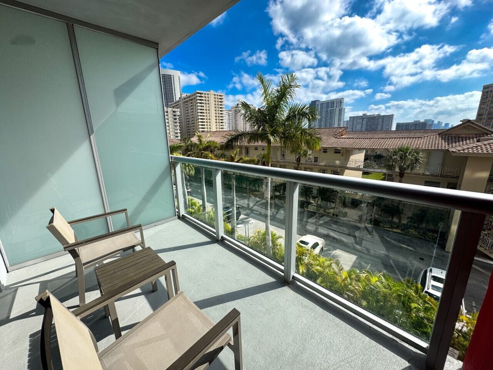 Private balcony with outdoor seating and refreshing views.