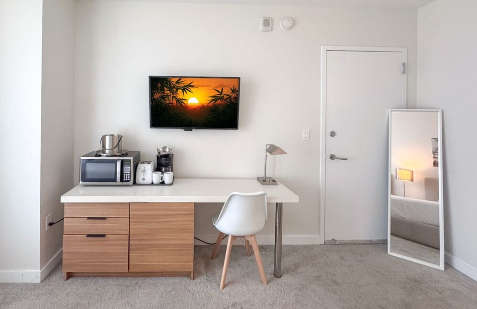 Well-equipped workspace and TV area inside the bedroom.