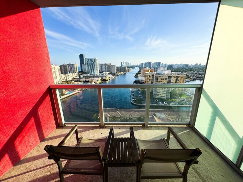 Private balcony with outdoor seating and skyline views.