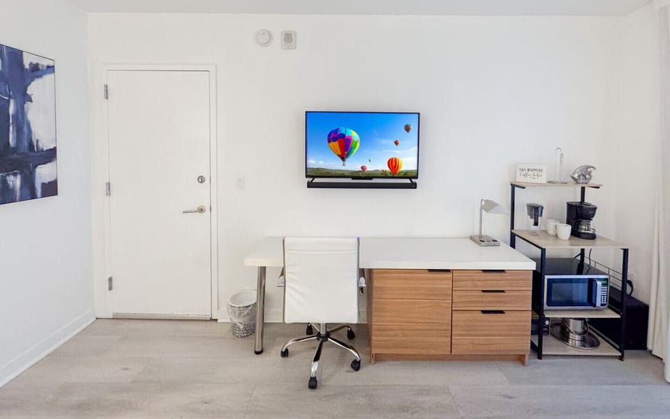 Well-equipped workspace and TV area inside the bedroom.