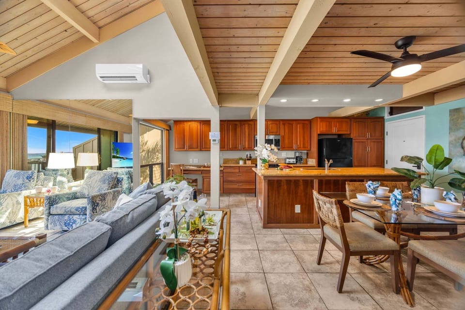 From sofa to kitchen, wood and granite blend with bar stools, the open plan inviting conversation.