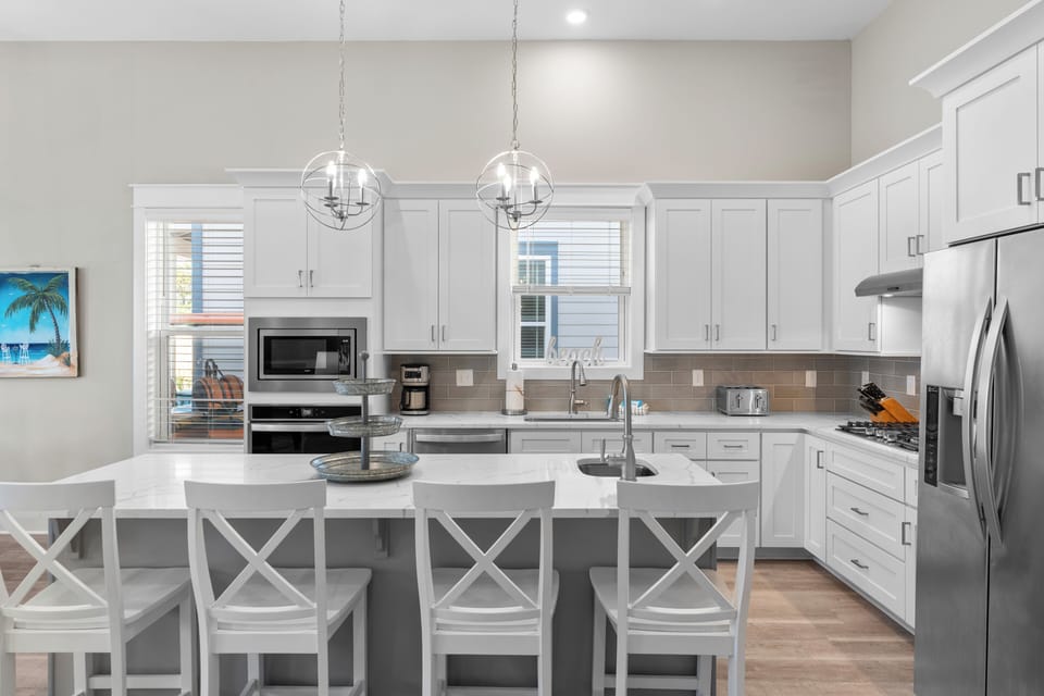 The kitchen features a counter island and bar seating.