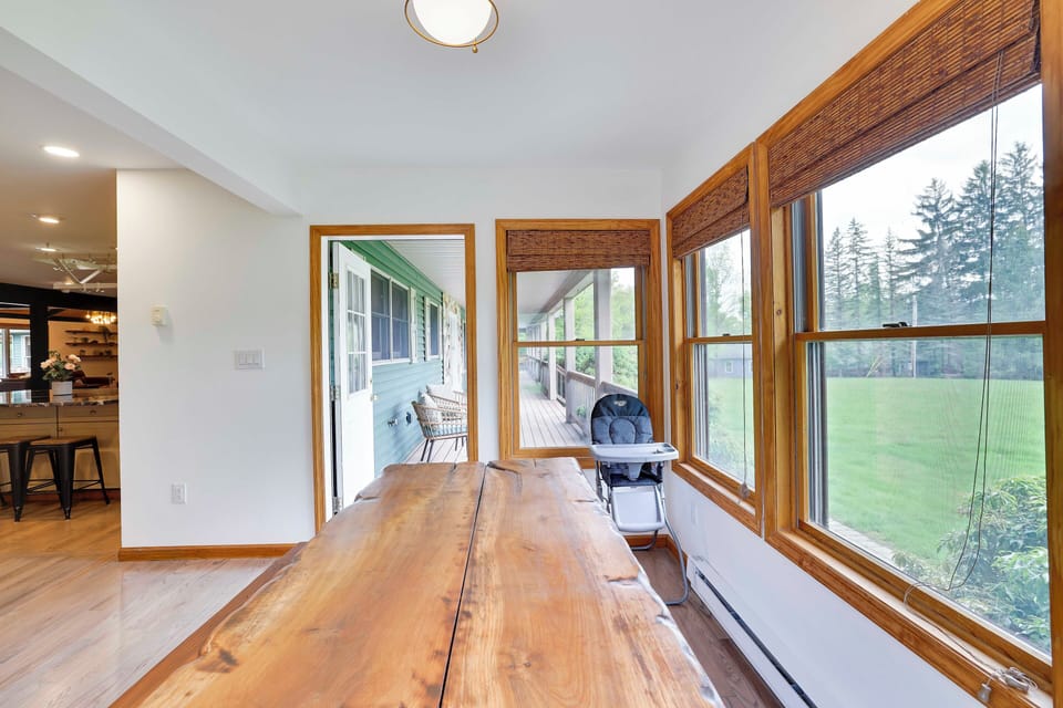 Breakfast table with high chair is surrounded by lush greenery