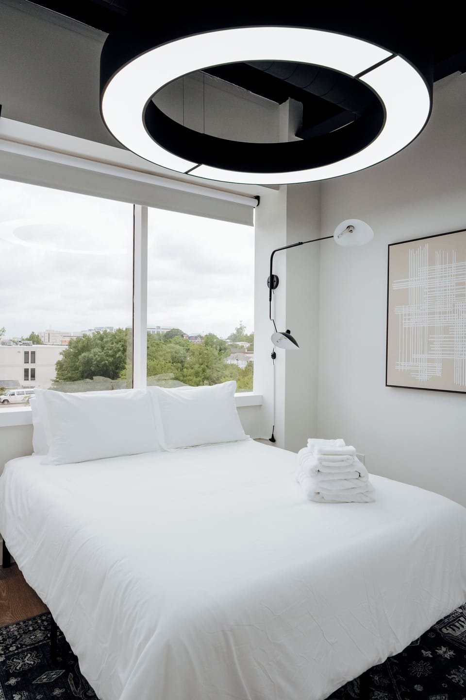 A cozy bed bathed in bright, natural light