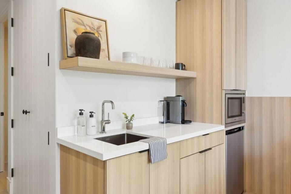 Nespresso, mini-fridge,  microwave/air-fryer, plates/utensils. No stove.
