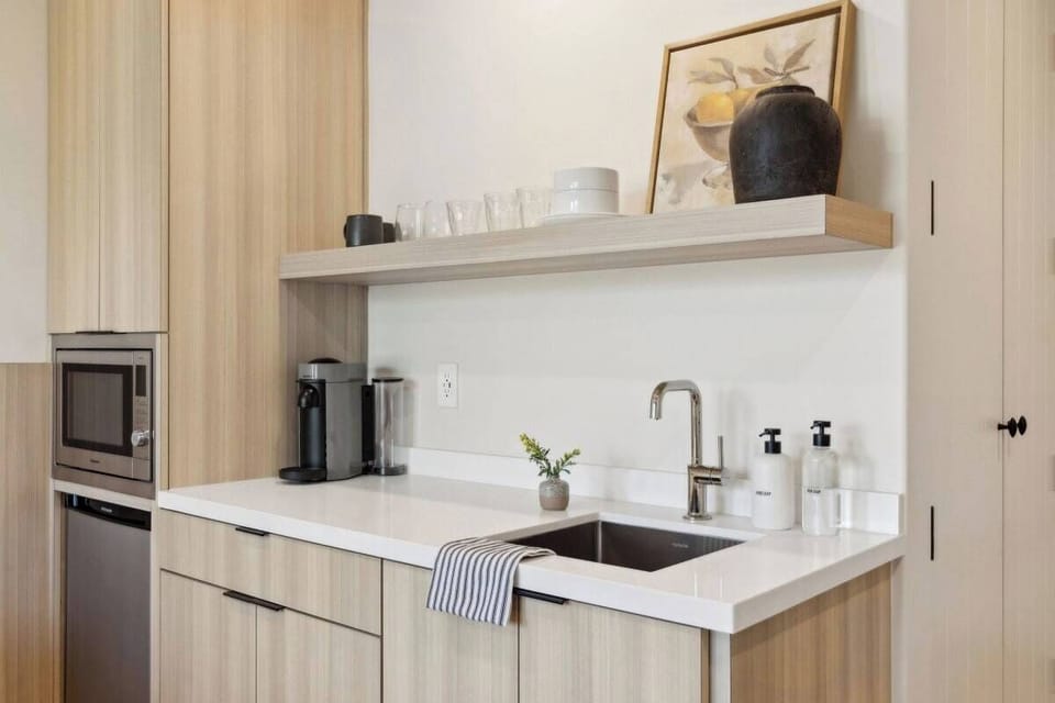 Nespresso, mini-fridge,  microwave/air-fryer, plates/utensils, no stove.