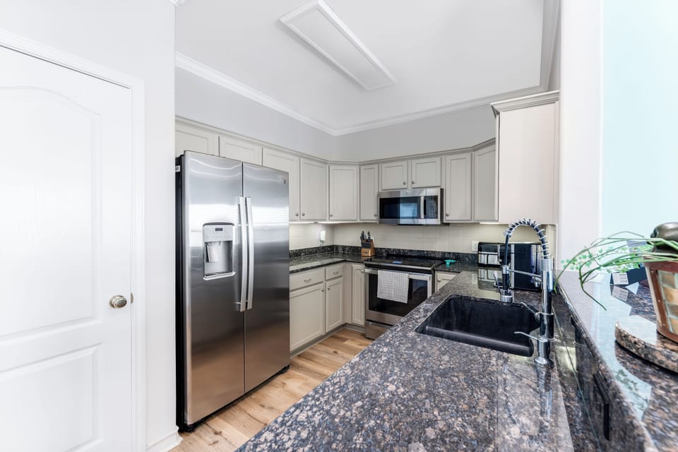 Your fully equipped kitchen features granite countertops, stainless steel appliances, and everything you need to create memorable meals.