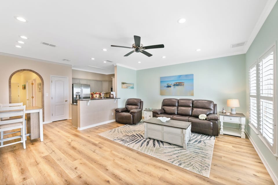Sink into plush leather seating in your bright, open living space with coastal touches and modern comfort.