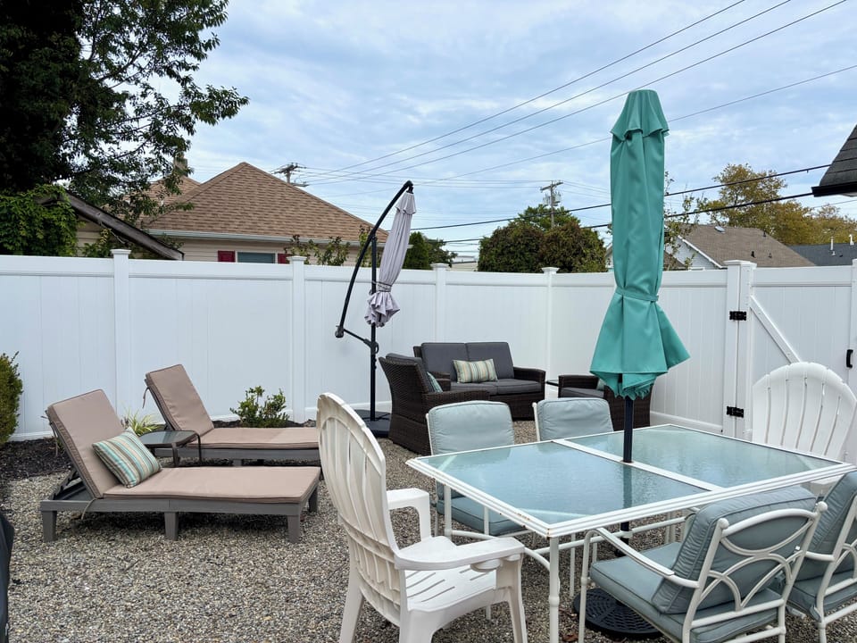 Fully private backyard with dining table, seating, BBQ, outdoor shower. 