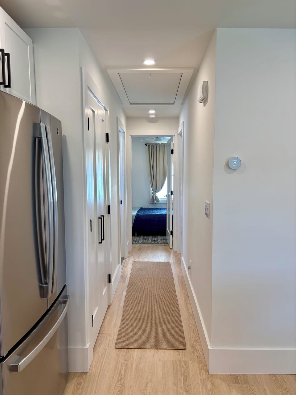 Hallway with half bath, access to bedrooms