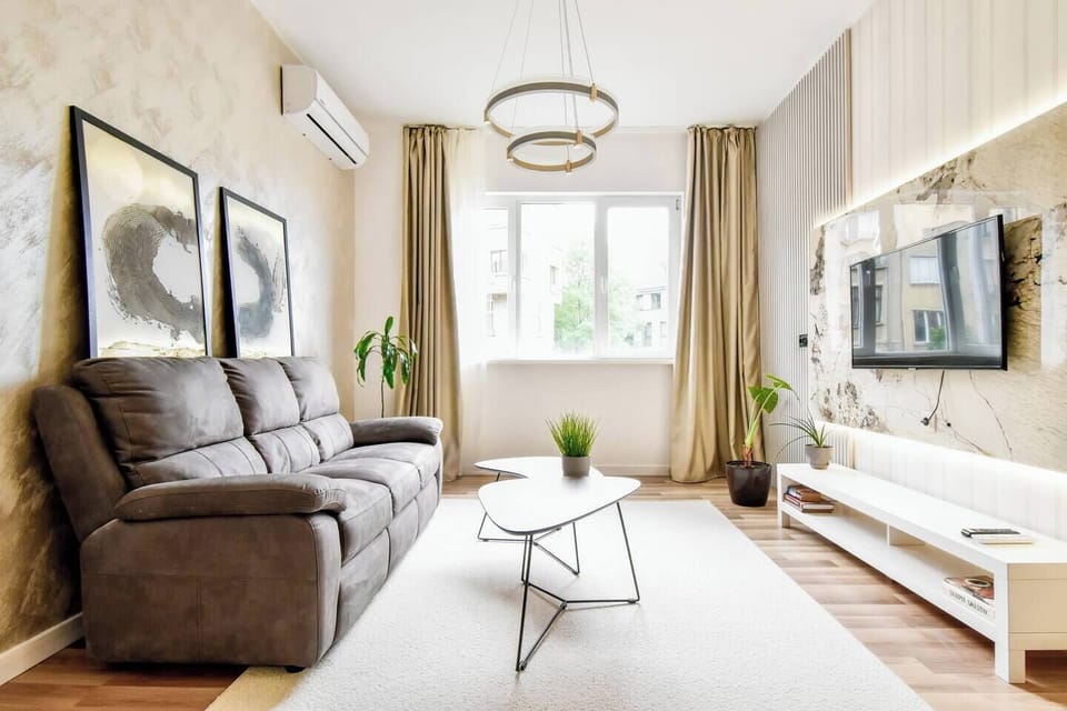 This sunlit lounge space is perfect for relaxing after a day out, with large windows, warm textures, and plenty of room to breathe.