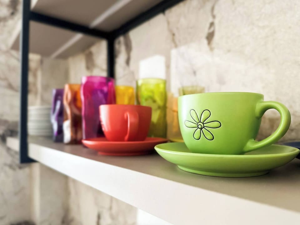 Colorful mugs and thoughtful touches give the kitchen a cheerful, homey feel—everything’s ready for your morning coffee.
