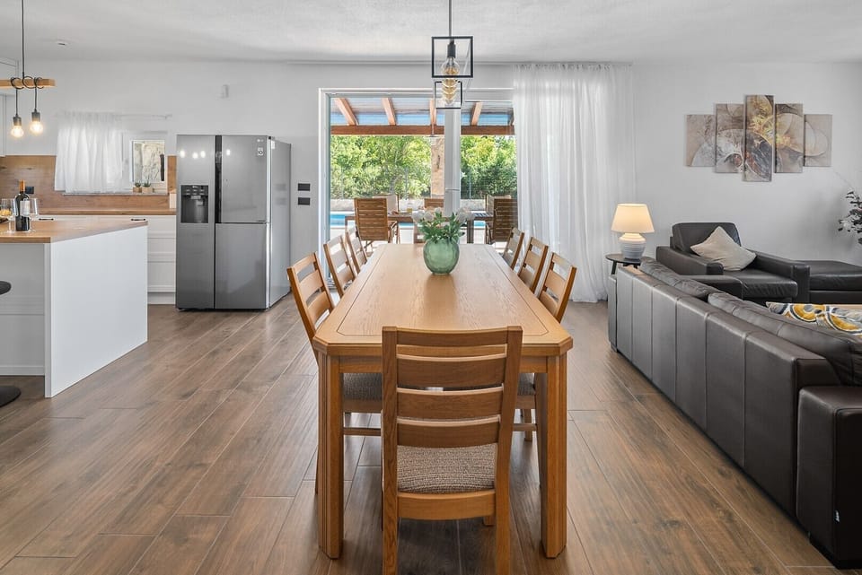 The dining table, which comfortably seats eight, and enjoy shared meals as you create lasting memories.