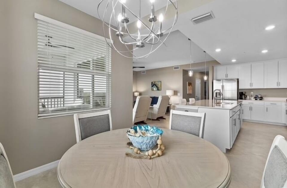 Dining room table off kitchen with view of course