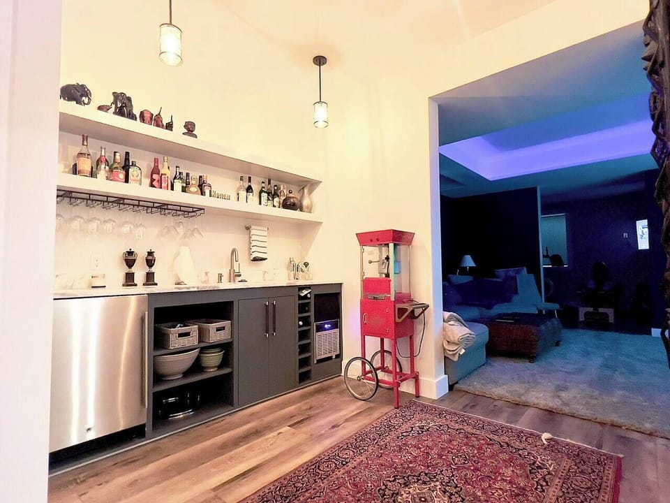 Home Theater Bar with Popcorn machine, ice maker, and mini fridge 
