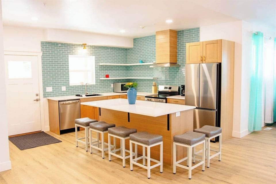 Large kitchen area with island and chairs